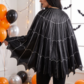 Woman wearing the spider web poncho