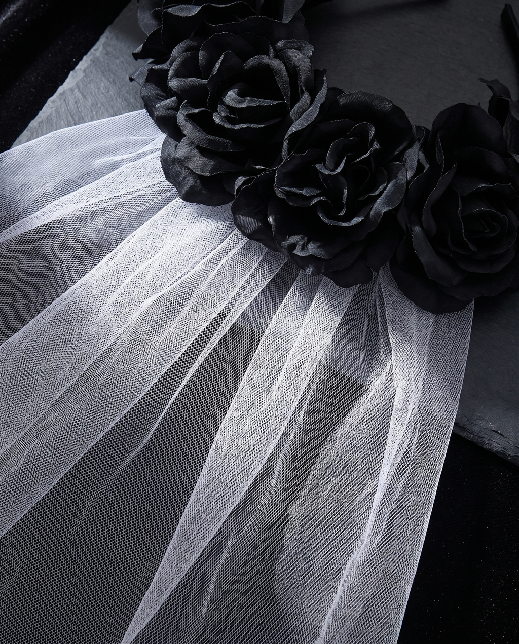 Detail of faux black roses and mesh veil