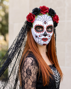 Woman wearing Day of the Dead rose and veil mask