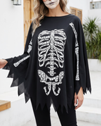 Person wearing black skeleton print poncho
