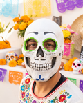 Man wearing green Day of the Dead skull latex mask
