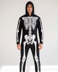 Man wearing UV glow skeleton hooded jumpsuit