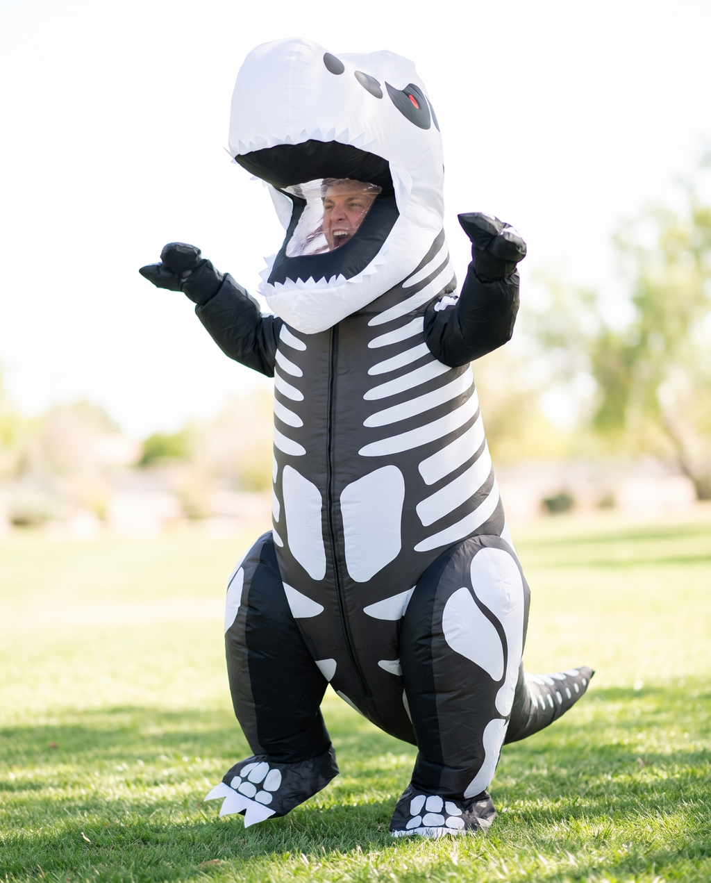 Person wearing skeleton T-rex inflatable costume