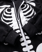 Detail of plush skeleton onesie zip and cuffs