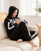 Person wearing plush fleece skeleton onesie