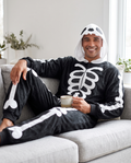 Person wearing skull hood skeleton onesie