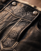 Detail of leather, embroidery and horn buttons