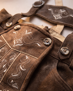 Detail of leather, embroidery and horn buttons